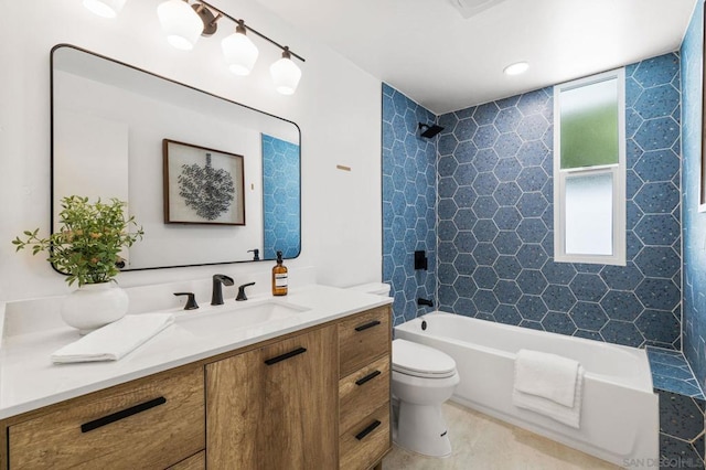 full bathroom with toilet, vanity, and tiled shower / bath