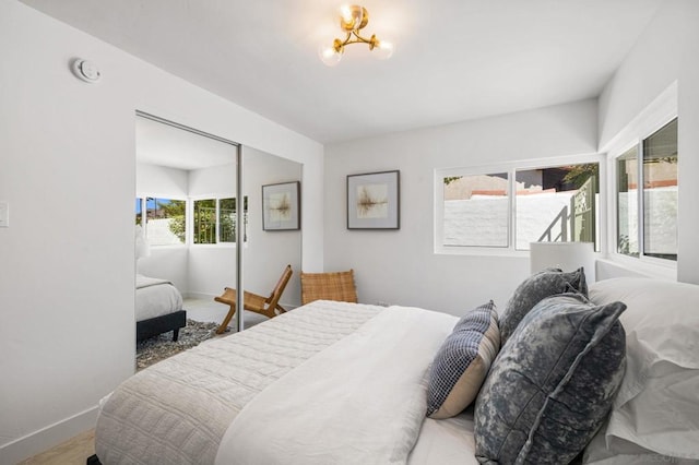 bedroom with an inviting chandelier and a closet