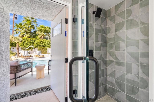 bathroom featuring a shower with shower door