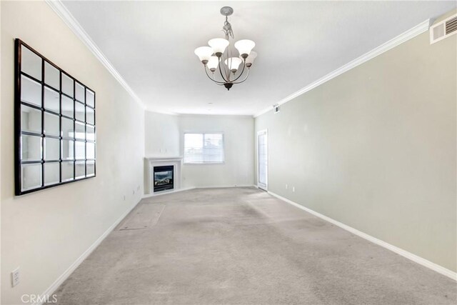 unfurnished living room featuring visible vents, carpet floors, a glass covered fireplace, and crown molding