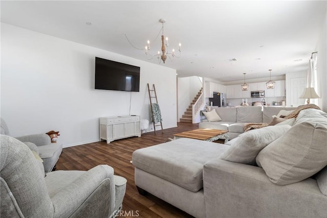 living room with an inviting chandelier and hardwood / wood-style floors