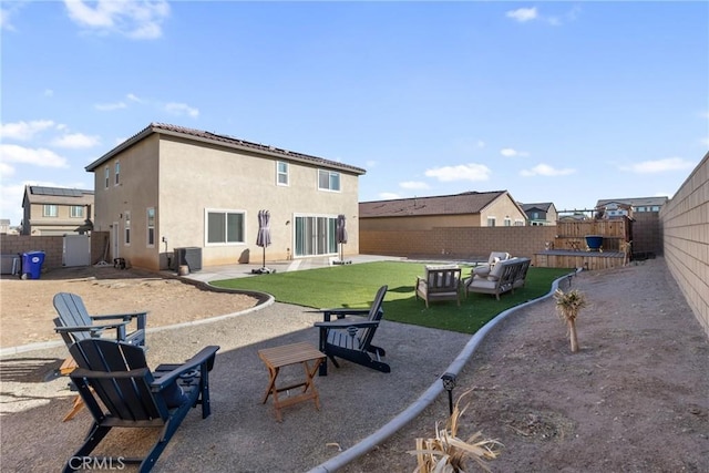 rear view of house with a patio area, cooling unit, and a yard