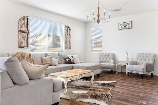 living room featuring a notable chandelier and dark hardwood / wood-style floors