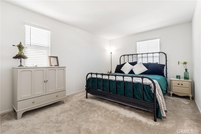 bedroom featuring light carpet