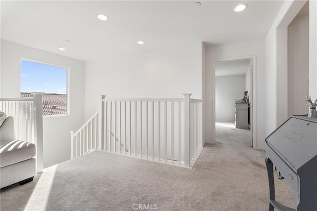 hallway featuring light carpet