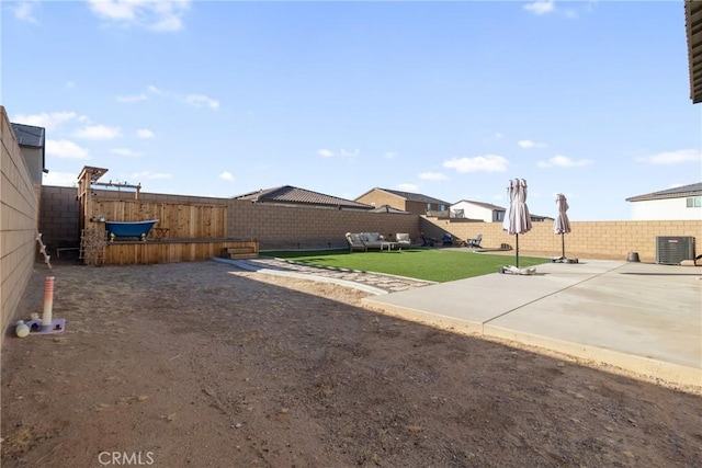 view of yard featuring central air condition unit and a patio