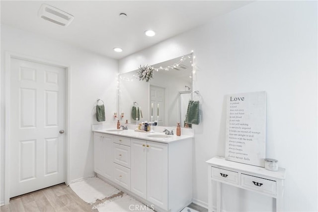 bathroom featuring hardwood / wood-style floors and vanity