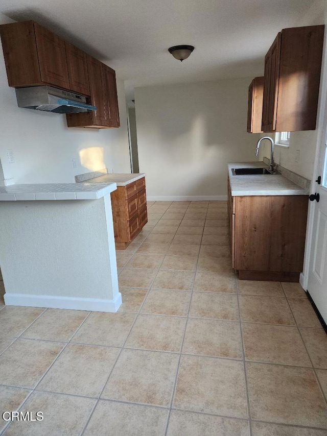 kitchen with sink and light tile patterned flooring