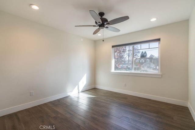 unfurnished room featuring ceiling fan and dark hardwood / wood-style flooring