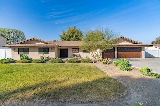 ranch-style home featuring a front lawn and a garage