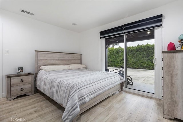 bedroom featuring access to exterior and light wood-type flooring