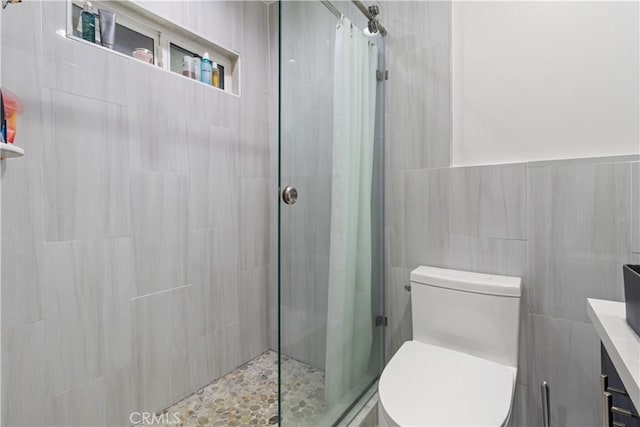 bathroom with a shower with shower door, tile walls, and toilet