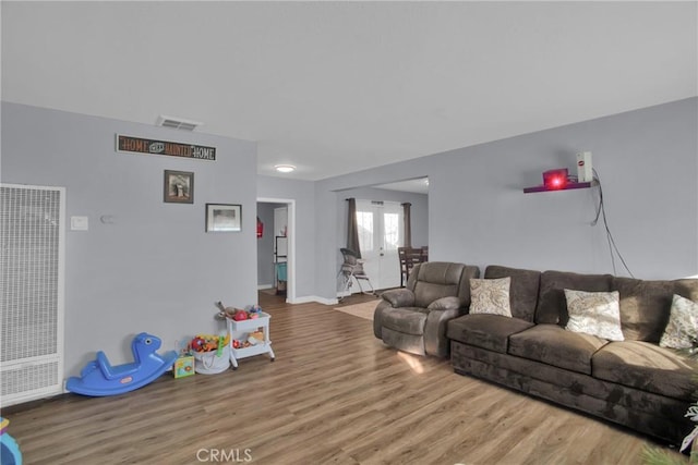 living room featuring hardwood / wood-style floors and french doors