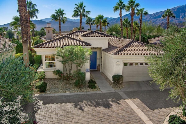 mediterranean / spanish house featuring a mountain view and a garage