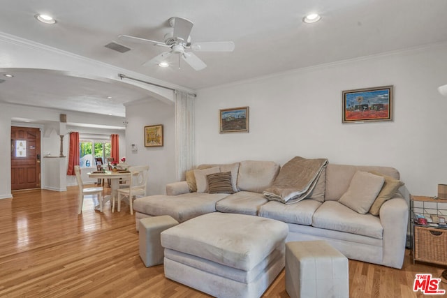 living room with ceiling fan, crown molding, and light hardwood / wood-style floors