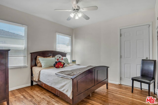 bedroom with ceiling fan and light wood-type flooring