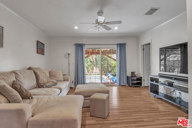 living room featuring ceiling fan, light wood-type flooring, and ornamental molding