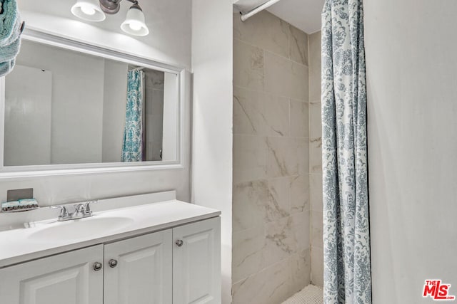 bathroom featuring vanity and a shower with shower curtain