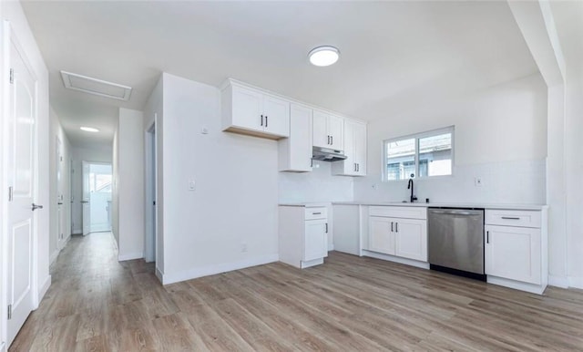 kitchen with stainless steel dishwasher, white cabinetry, under cabinet range hood, a sink, and light wood-style flooring