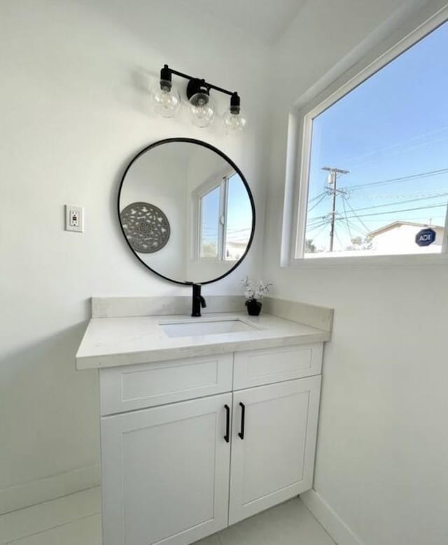 bathroom featuring baseboards and vanity