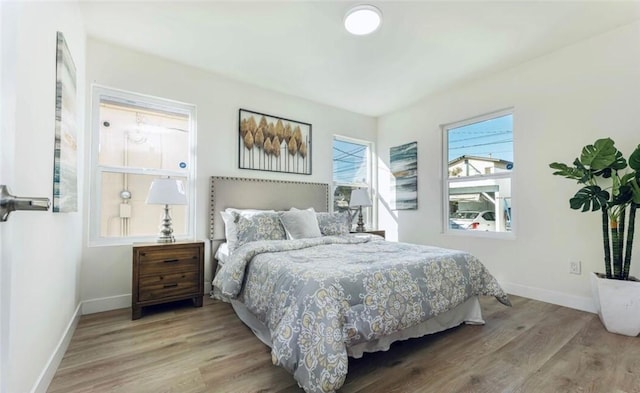 bedroom featuring baseboards and wood finished floors