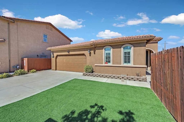 mediterranean / spanish house with a garage