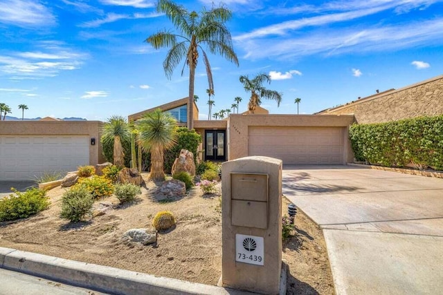 view of front of property featuring a garage and french doors