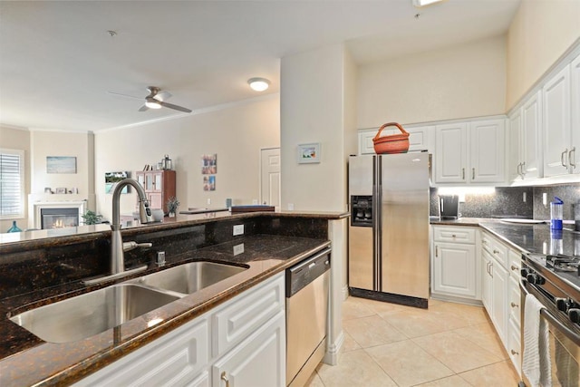 kitchen with sink, light tile patterned floors, crown molding, appliances with stainless steel finishes, and white cabinetry