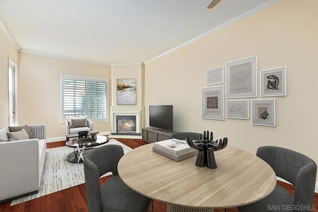 dining space with crown molding and wood-type flooring