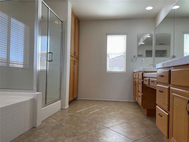 bathroom featuring vanity and independent shower and bath