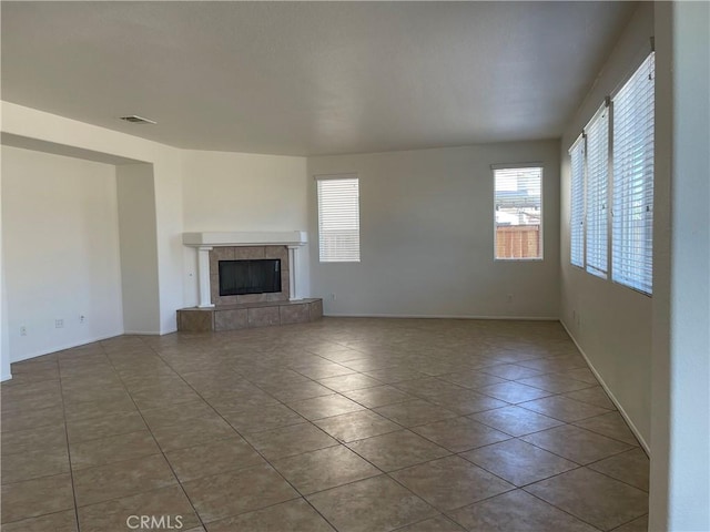 unfurnished living room featuring tile patterned floors and a tile fireplace