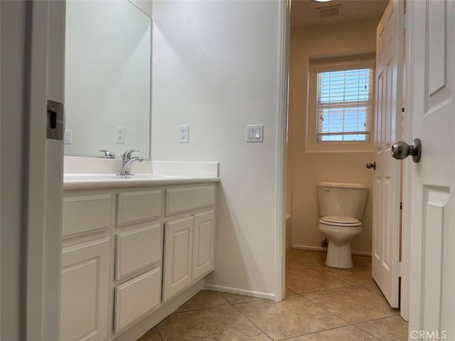 bathroom featuring toilet, tile patterned flooring, a tub, and vanity