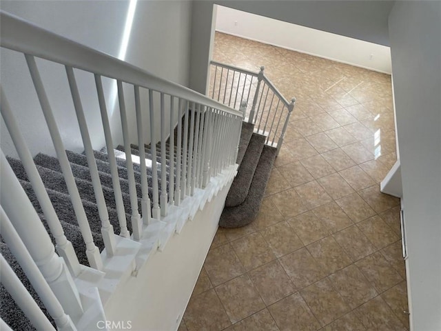 stairway with tile patterned floors