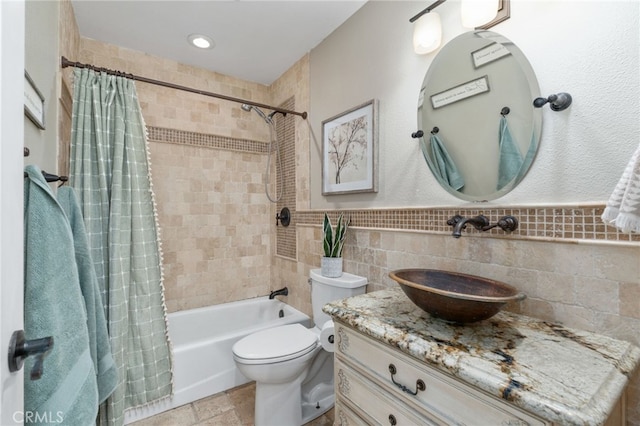 full bathroom featuring toilet, vanity, tile walls, and shower / tub combo with curtain