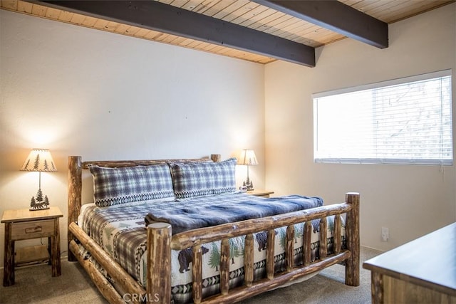 carpeted bedroom with wooden ceiling, multiple windows, and beamed ceiling