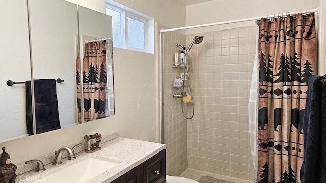 bathroom featuring toilet, vanity, and a shower with shower curtain