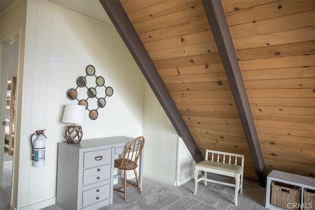 home office featuring lofted ceiling with beams, wood ceiling, wooden walls, and carpet flooring