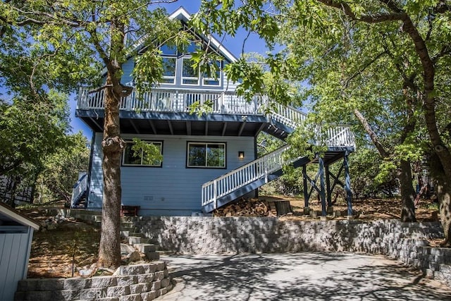 rear view of house featuring a deck