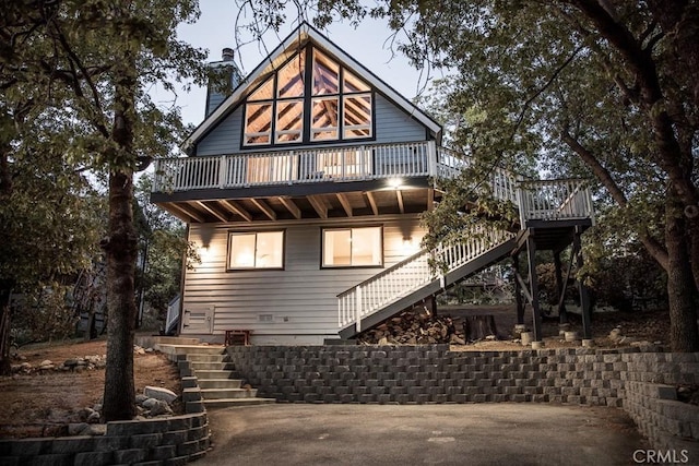 back of house featuring a wooden deck