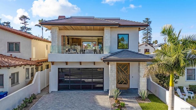 view of front facade with a balcony and a garage