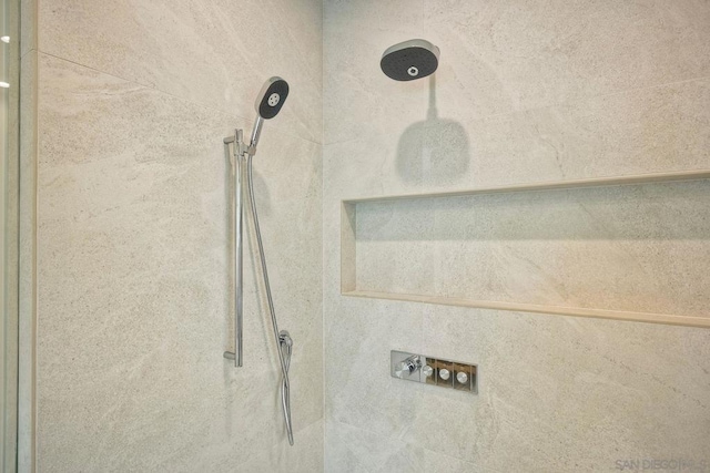 interior details with a tile shower