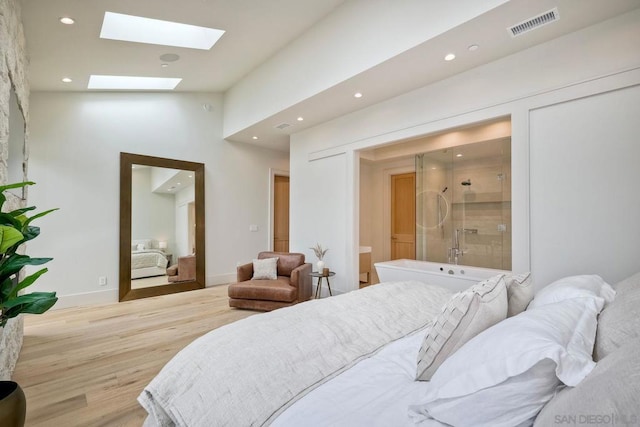 bedroom featuring lofted ceiling and light wood-type flooring