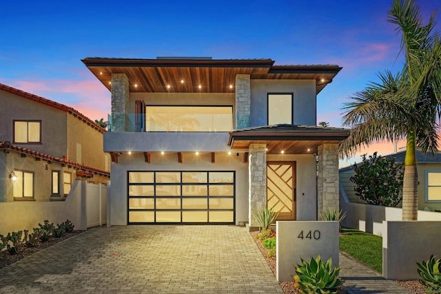 modern home featuring a balcony and a garage