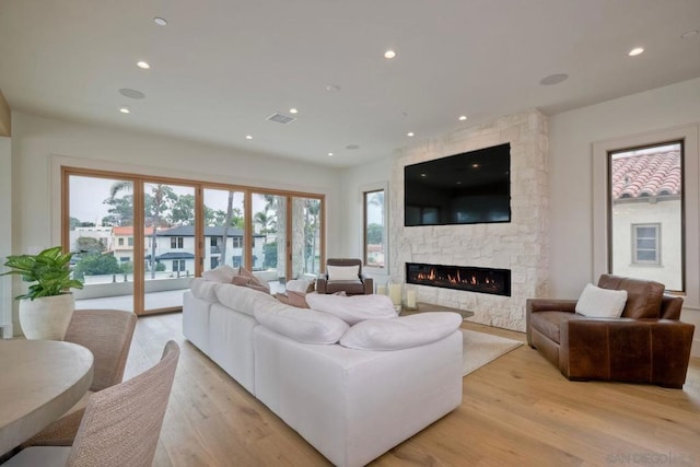 living room with a fireplace and light hardwood / wood-style floors