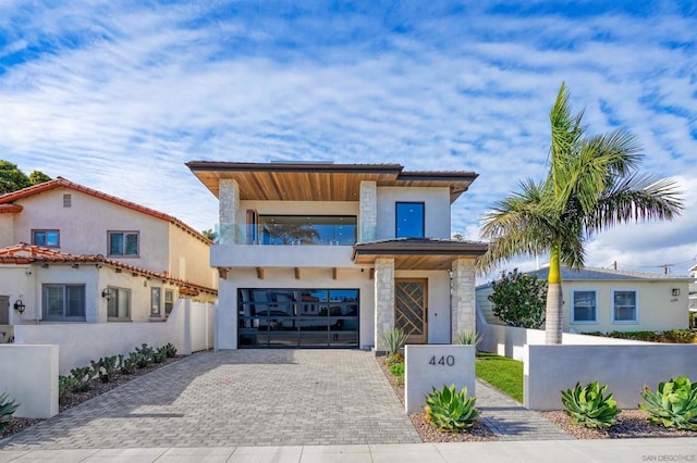 view of front of home with a balcony and a garage