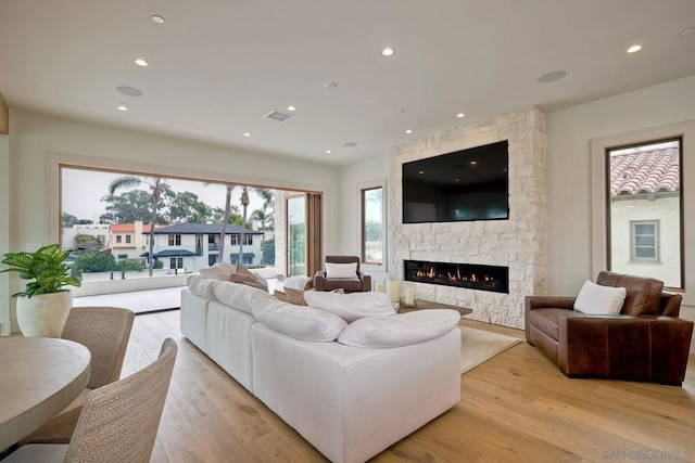 living room with a fireplace and light hardwood / wood-style flooring