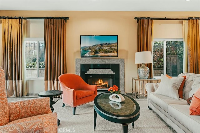 living area with a tiled fireplace