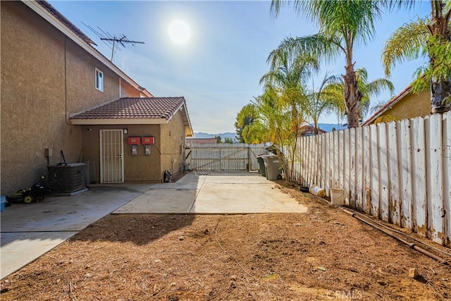 view of yard featuring a patio area and central AC unit