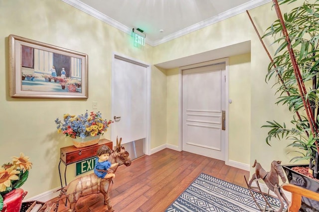 corridor featuring light wood-type flooring and crown molding