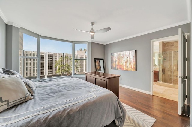 bedroom with ceiling fan, ornamental molding, dark hardwood / wood-style floors, and ensuite bath